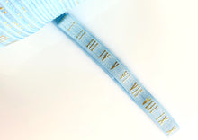 Load image into Gallery viewer, Gold Roman Numerals on Baby Blue - FOE -  Fold Over Elastic -  Fantastic Elastic Company
